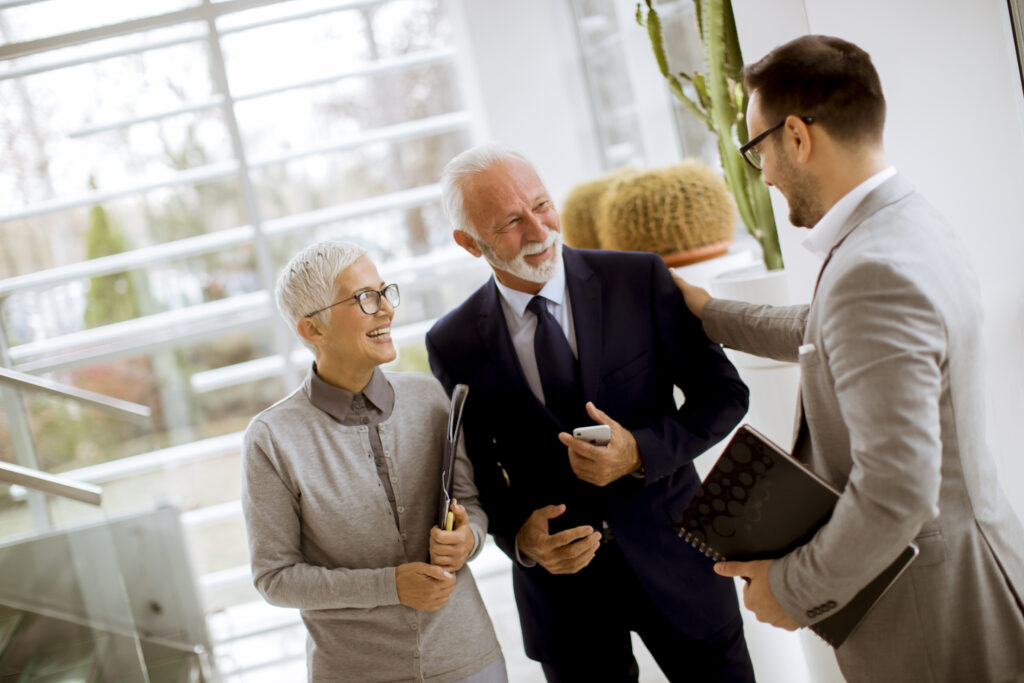 Real estate agent smiling at seniors over their common Handyman needs.